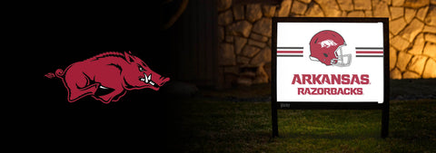 Arkansas Razorbacks logo and sign on a dark background